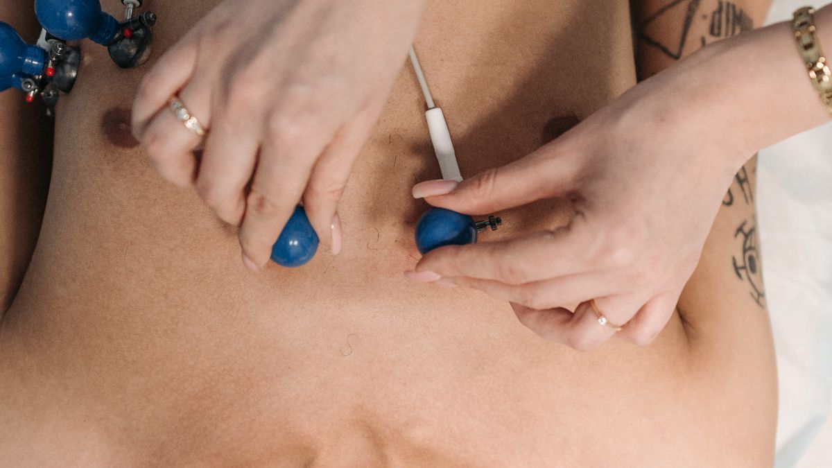 Healthcare professional placing ECG electrodes on a patient's chest to check for a heart attack