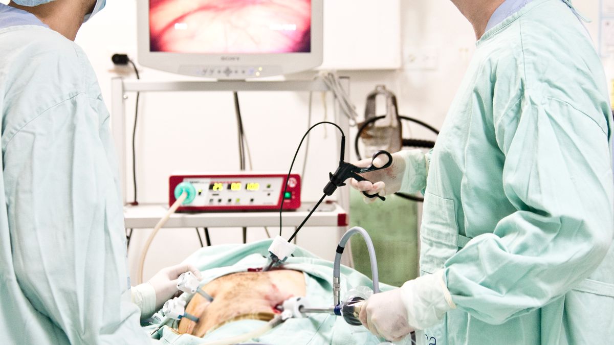 Surgical team performing laparoscopic keyhole surgery in a hospital operating room